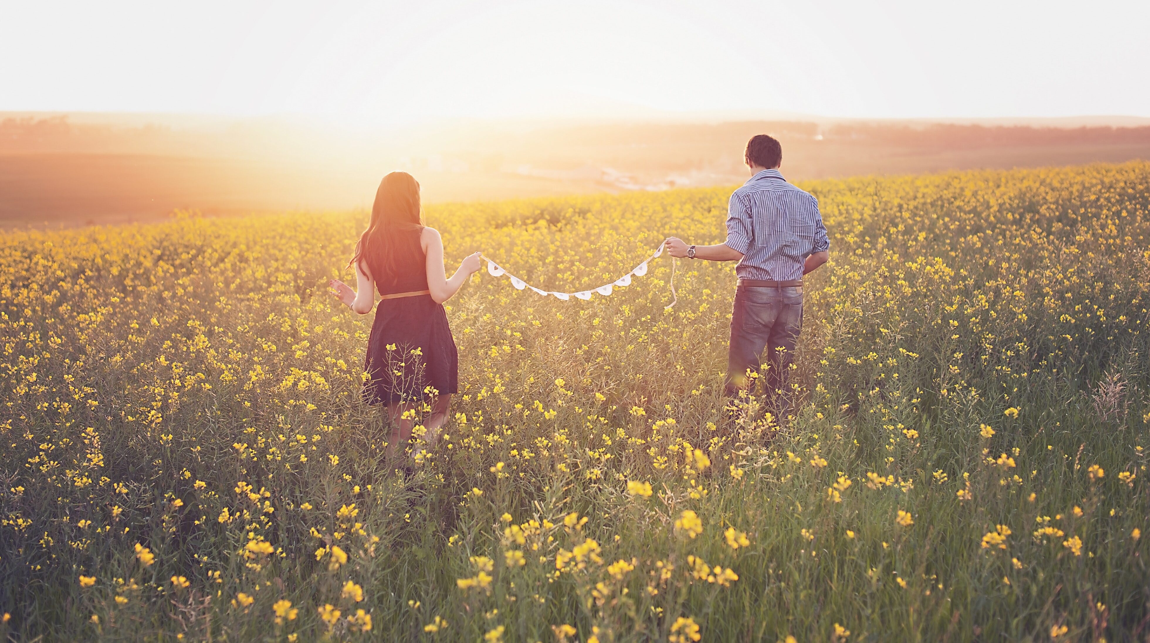 Happy Couple in Field - Therapy and Counseling